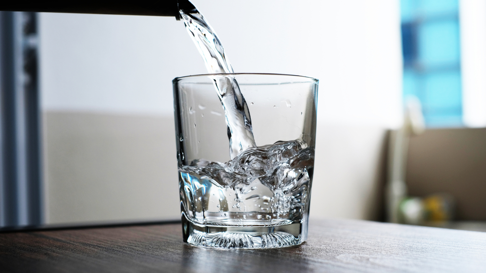 water to drink poured into a glass.